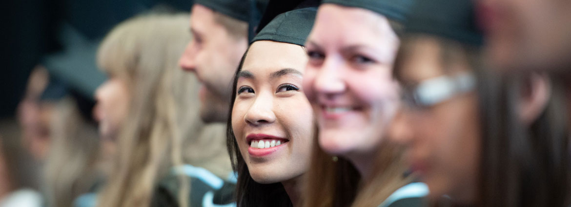 A smiling student at graduation